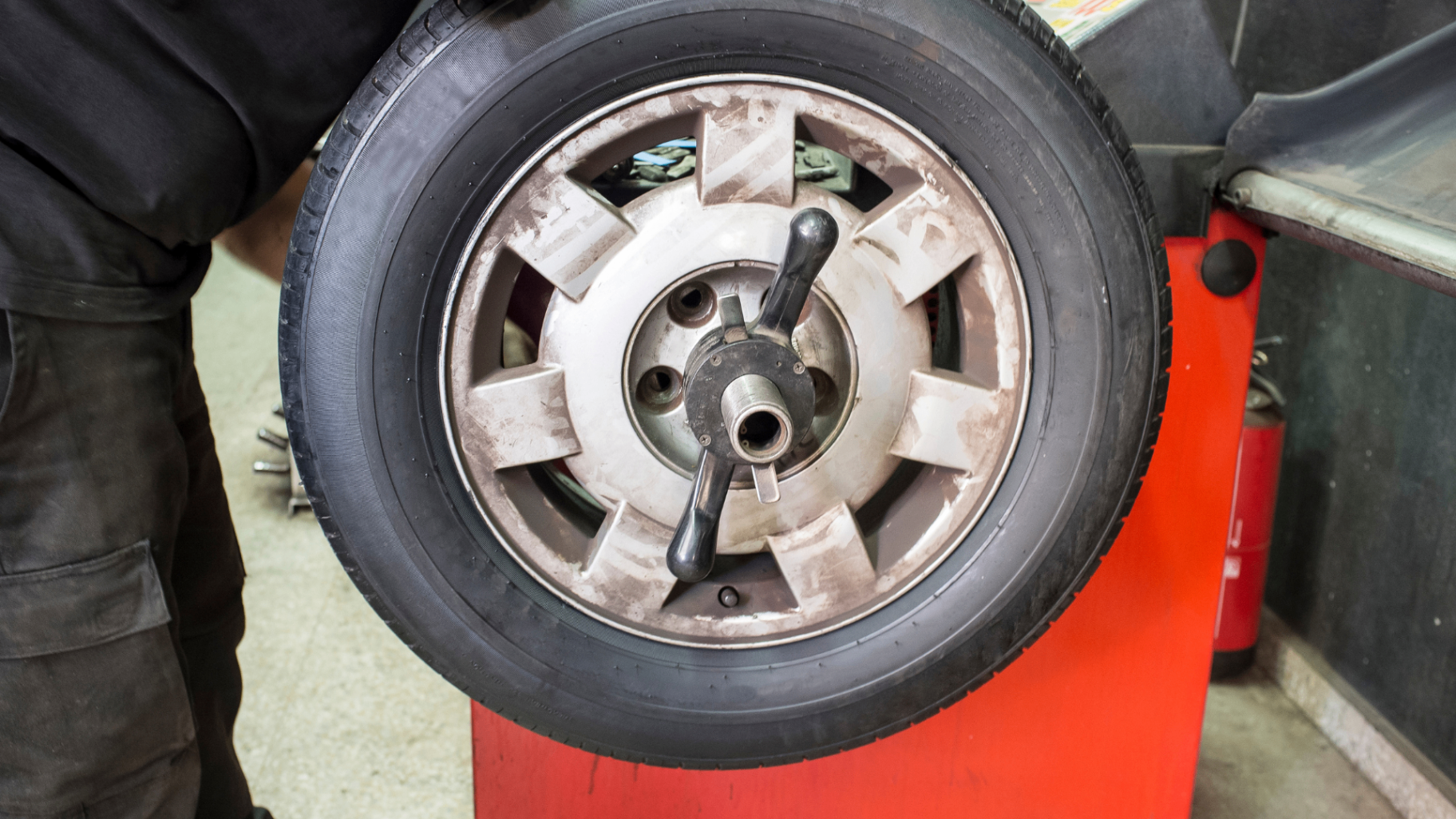 Alloy wheel and tyre mounted on a professional wheel balancer